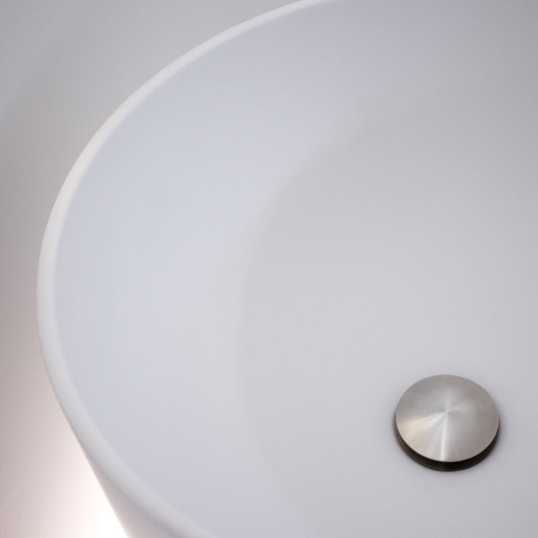 Washbasins Freestanding washbasin (Ø 425 mm, H. 900 mm) in Biobased Solid Surface with floor drainage and LED floor lighting (3000K). Siphoned free flow waste drain (PIL31) not included Washbasins CEA Design